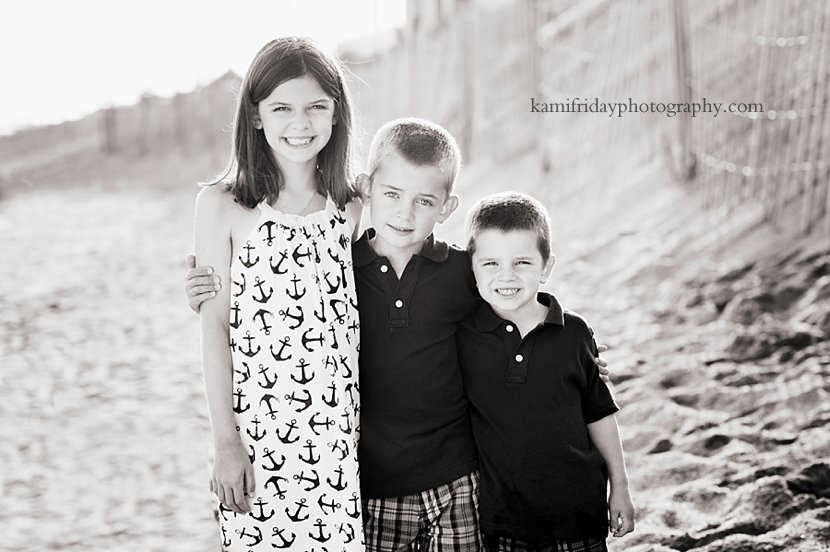 Siblings pose for portrait on the beach in Dennisport, MA