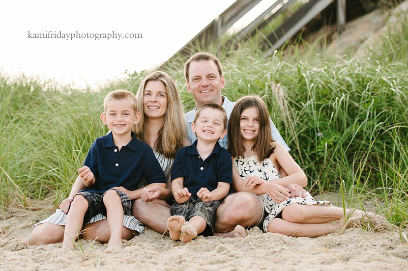 Greater Boston Family Photographer takes portrait of family on Cape Cod beach in front of dune