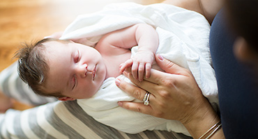 Hollis NH Newborn photographer photographs baby holding her mother's hand