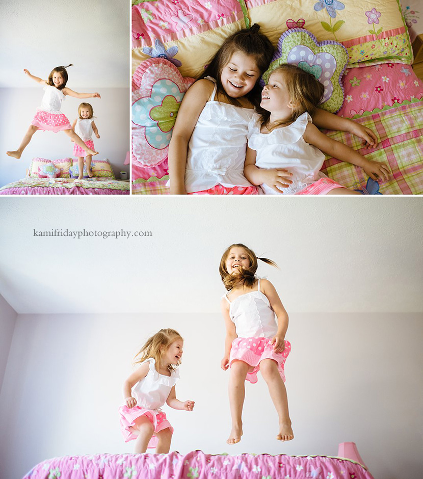 Sisters share giggles as they jump on their bed.