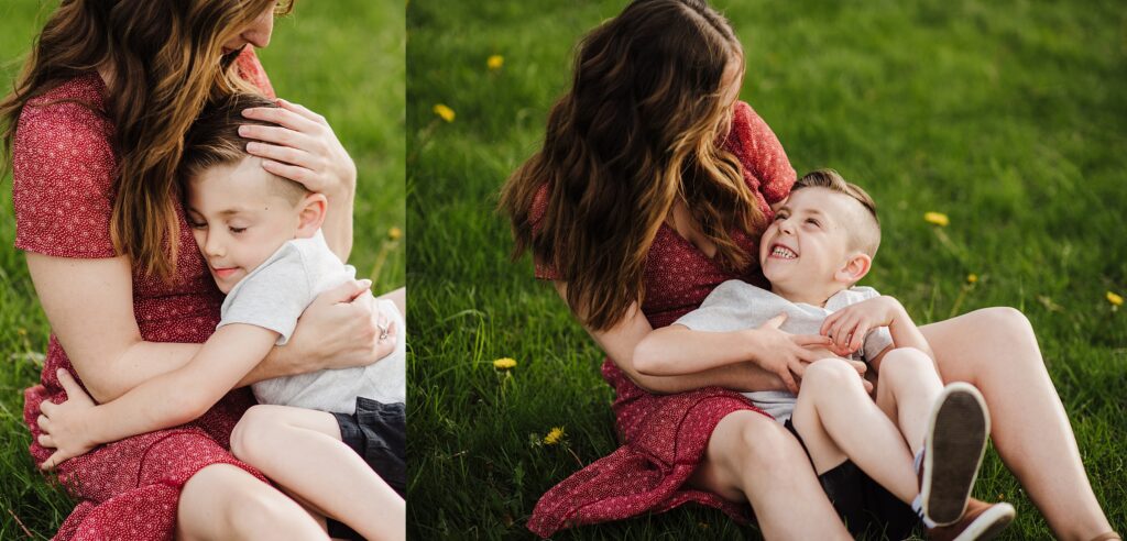 Spring family photo shoot in Nashua NH.  Mother and son share laughs and cuddles in grassy field.