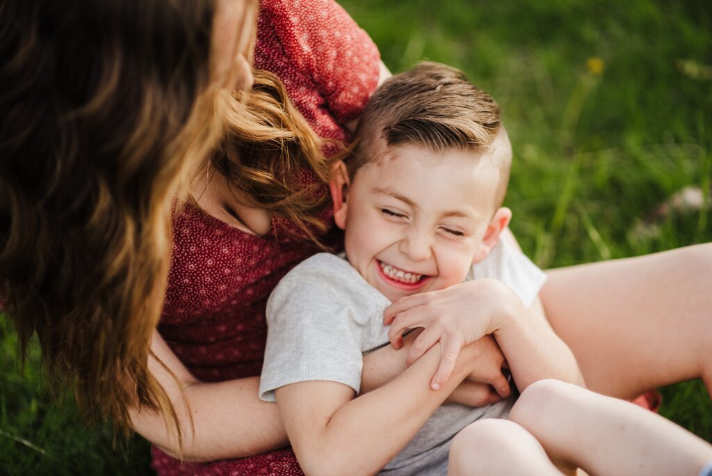 A candid moment of laughter between mother and sons, captured by New Hampshire photographer, Kami Friday.