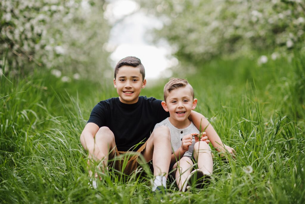 Two brothers pose lovingly in a Londonderry NH farm field.