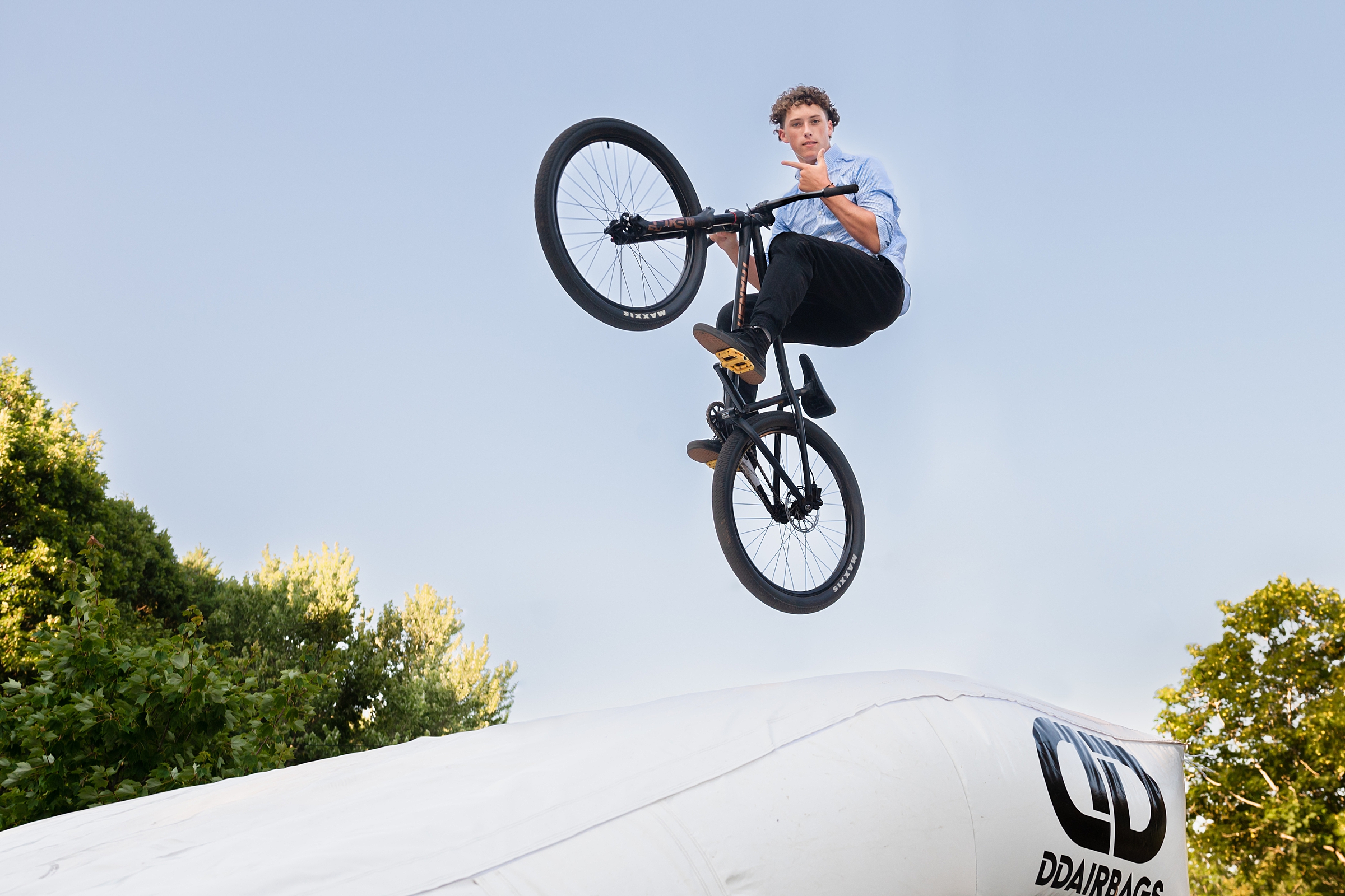Bishop Guertin High School Senior boy jumps his bike through the air off a ramp.