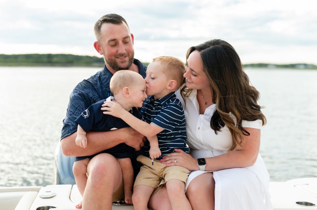 Kennebunkport parents are photographed while holding kissing sons.