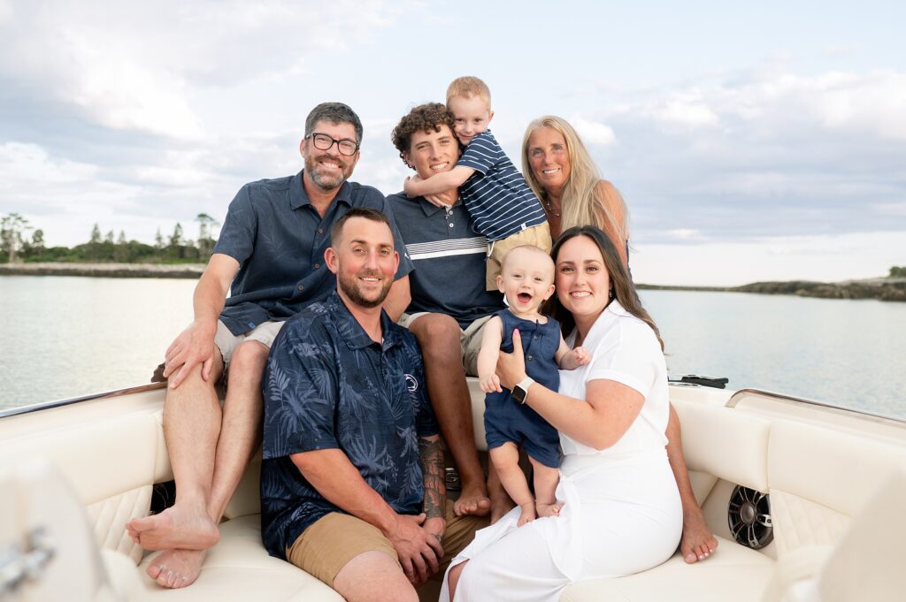 Parents, kids and grandparents smile for a portrait session on their Kennebunkport boat.