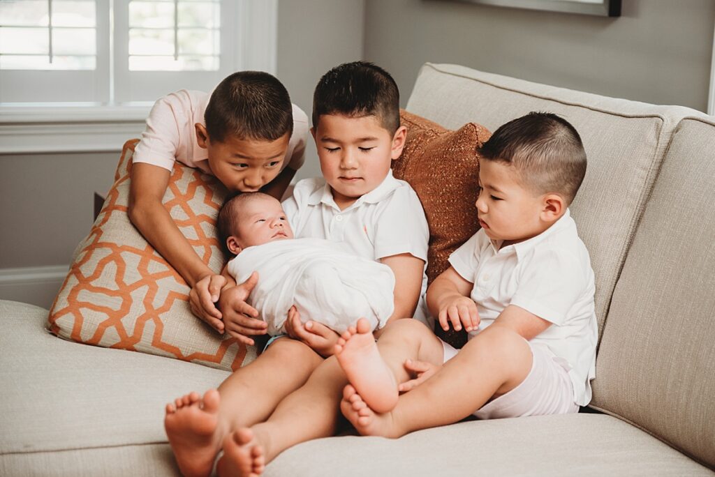Newborn photos with siblings during lifestyle session at home in Hollis NH.